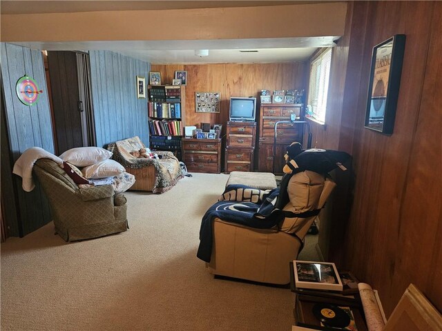 bedroom with wooden walls and carpet flooring
