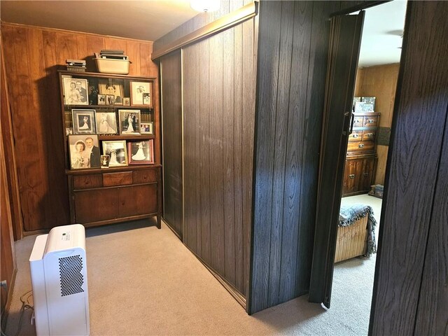 corridor with wood walls and carpet