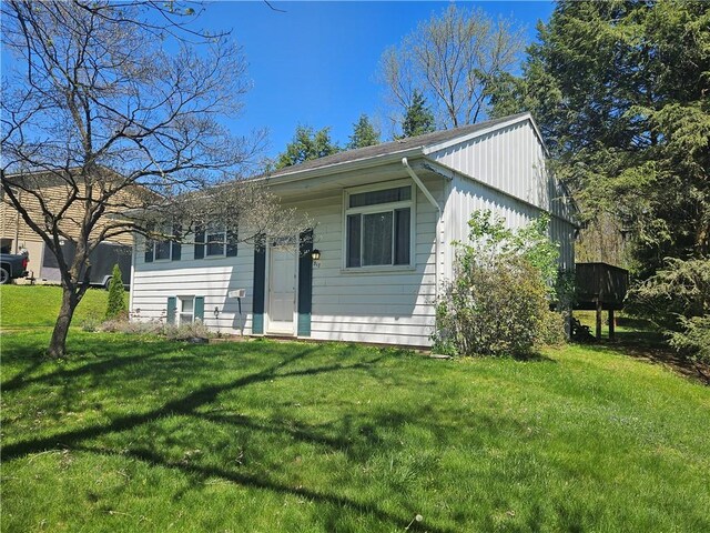view of front of home with board and batten siding and a front yard