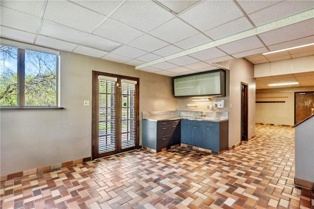 2408 Georgette St, Overbrook, PA 15234 - kitchen with baseboards, stainless steel countertops, a drop ceiling, and french doors