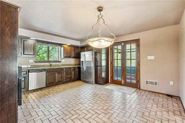 2408 Georgette St, Overbrook, PA 15234 - kitchen with french doors, visible vents, appliances with stainless steel finishes, brick floor, and a wealth of natural light