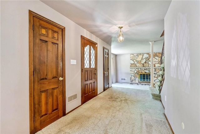 2408 Georgette St, Overbrook, PA 15234 - carpeted foyer featuring a chandelier, a stone fireplace, and visible vents