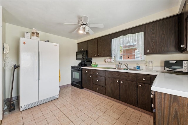 kitchen featuring dark brown cabinets, a sink, and black appliances