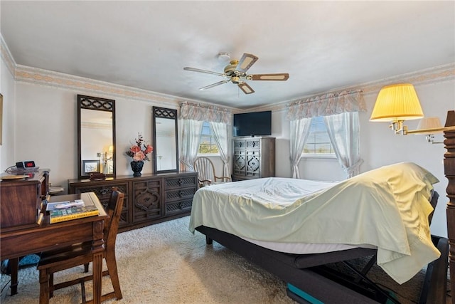 bedroom with carpet floors, ornamental molding, a ceiling fan, and multiple windows