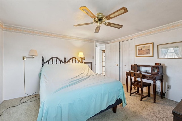 bedroom featuring ornamental molding, light carpet, a closet, and ceiling fan