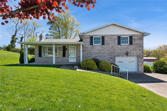 tri-level home with brick siding, a garage, a chimney, and aphalt driveway