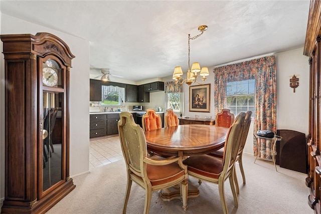 dining space featuring an inviting chandelier and light colored carpet