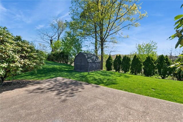 exterior space featuring a storage shed and an outbuilding