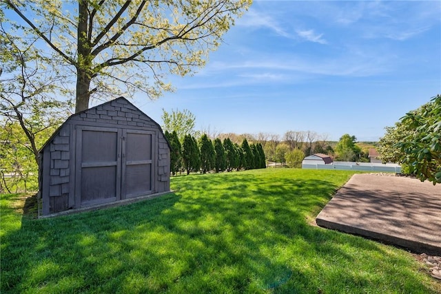 view of yard featuring a shed and an outbuilding