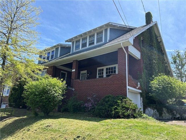 view of side of home featuring a garage, a chimney, a yard, and brick siding
