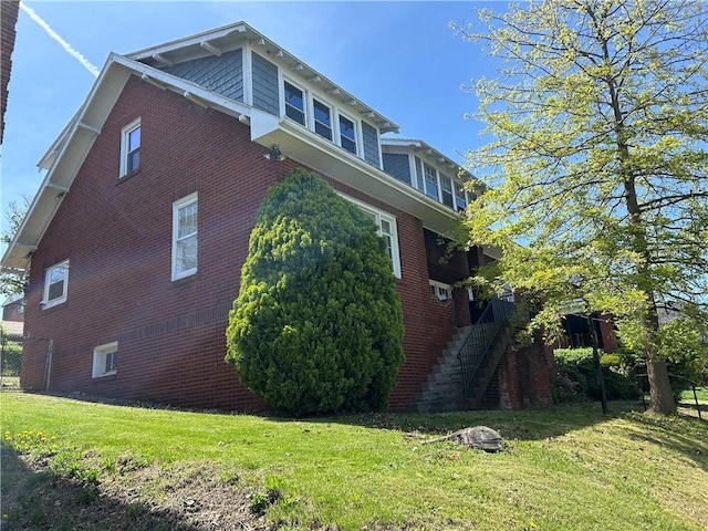 10 Frick Ave, Mount Pleasant Boro, PA 15666 - view of property exterior featuring stairs, a yard, and brick siding