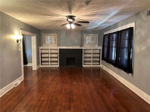 unfurnished living room with ceiling fan, visible vents, a fireplace, wood finished floors, and baseboards