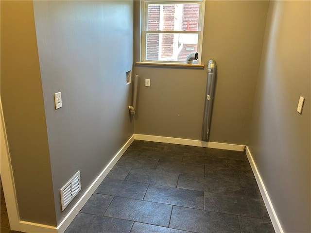 doorway with baseboards and visible vents