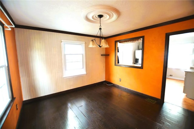 empty room with crown molding, baseboards, visible vents, and dark wood-type flooring