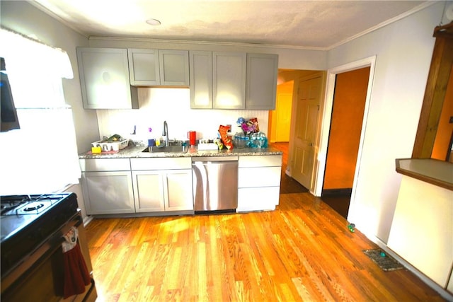 kitchen with gray cabinetry, black gas range oven, a sink, and dishwasher