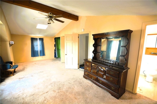 interior space with ceiling fan, light colored carpet, and lofted ceiling with skylight