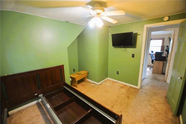 interior space featuring baseboards, ceiling fan, and carpet flooring