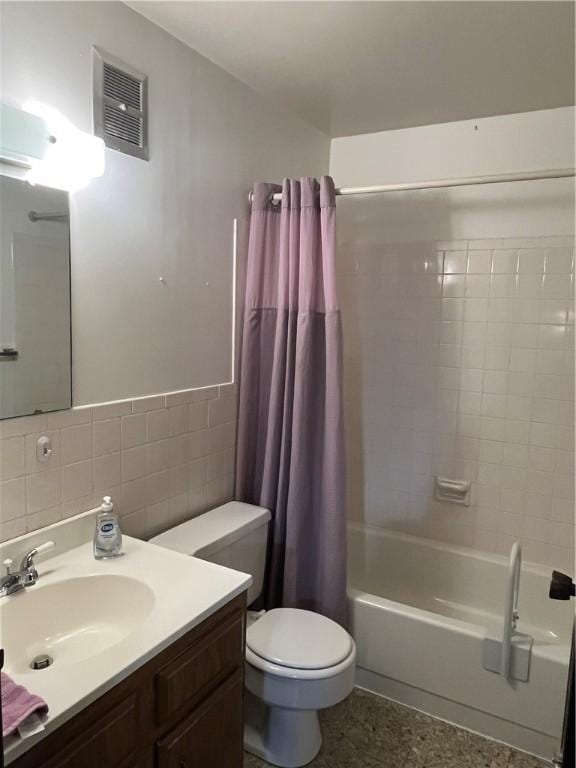 full bath with visible vents, tile walls, vanity, toilet, and shower / bathtub combination with curtain