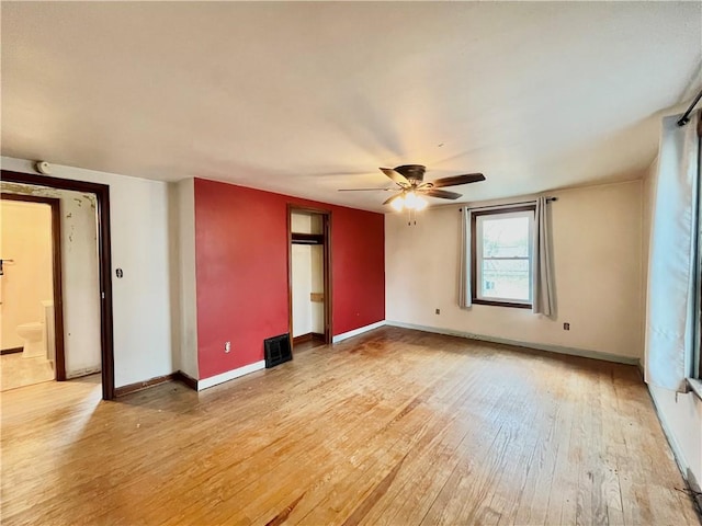unfurnished room featuring baseboards, ceiling fan, and light wood finished floors