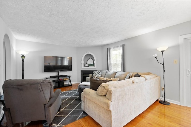 1470 Yorktown Dr, Cecil, PA 15055 - living area featuring arched walkways, a textured ceiling, and wood finished floors