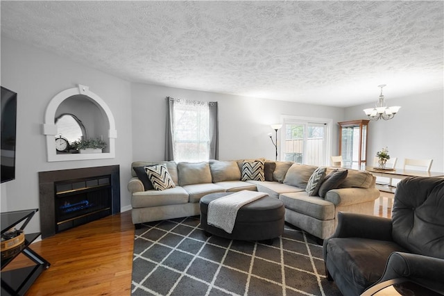 1470 Yorktown Dr, Cecil, PA 15055 - living area with an inviting chandelier, plenty of natural light, wood finished floors, and a fireplace