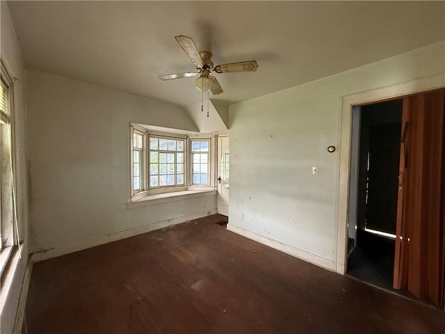 interior space with a ceiling fan, baseboards, and wood finished floors