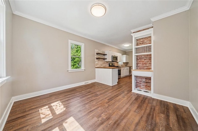 unfurnished living room with dark wood-type flooring, ornamental molding, and baseboards