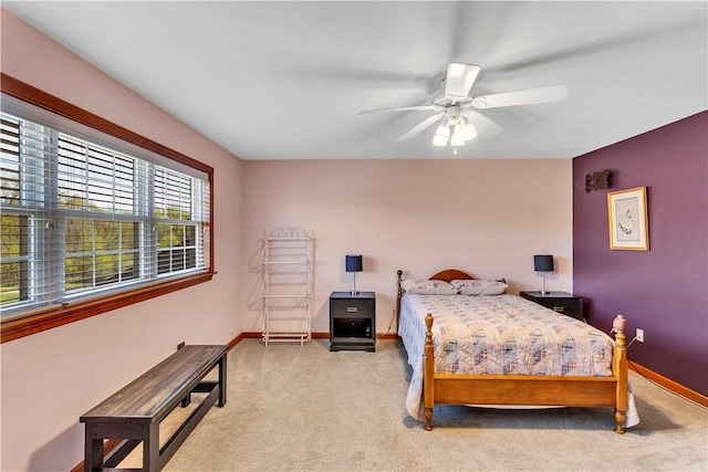 carpeted bedroom featuring a ceiling fan and baseboards