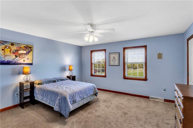 bedroom featuring carpet floors, baseboards, a ceiling fan, and visible vents