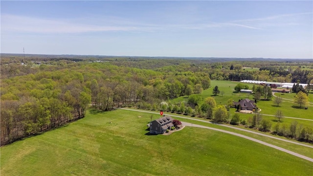 bird's eye view with a wooded view
