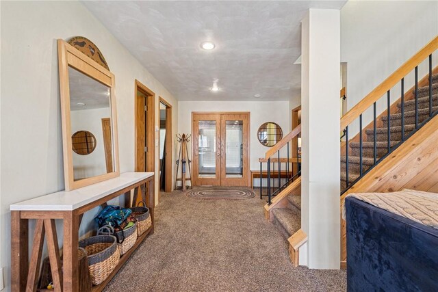 foyer entrance with carpet floors, stairs, recessed lighting, and french doors