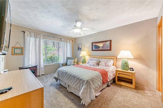 bedroom with ceiling fan and light colored carpet
