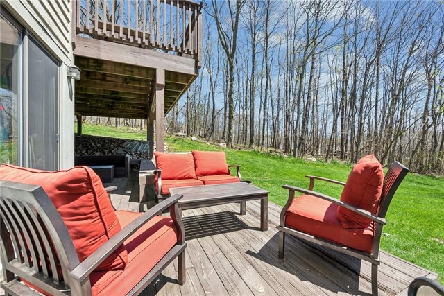 wooden deck with a yard and an outdoor hangout area