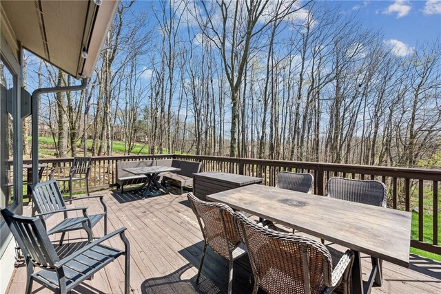 wooden terrace featuring outdoor dining space