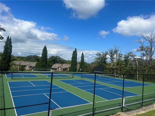 view of tennis court with fence