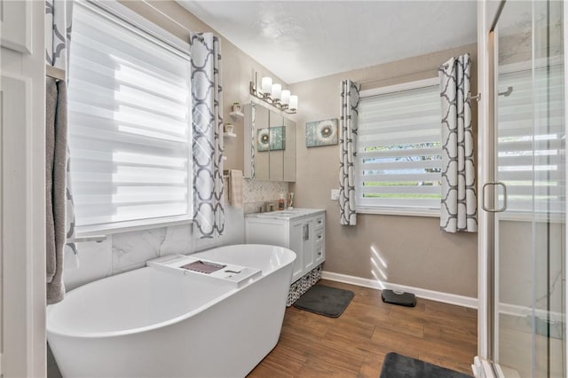 244 S Rebecca St, Saxonburg Boro, PA 16056 - full bath with a freestanding tub, tasteful backsplash, wood finished floors, baseboards, and vanity