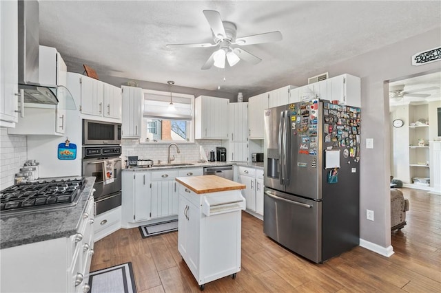 244 S Rebecca St, Saxonburg Boro, PA 16056 - kitchen with ceiling fan, a center island, a warming drawer, stainless steel appliances, and butcher block countertops