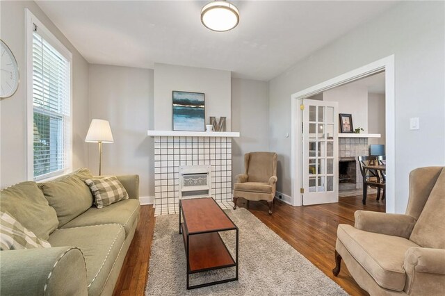 4004 Windsor St, Greenfield, PA 15217 - living area with baseboards, plenty of natural light, a fireplace, and wood finished floors