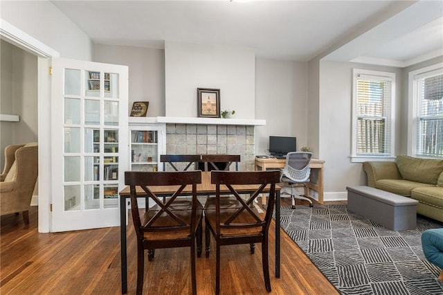 4004 Windsor St, Greenfield, PA 15217 - dining room featuring baseboards, wood finished floors, and a fireplace