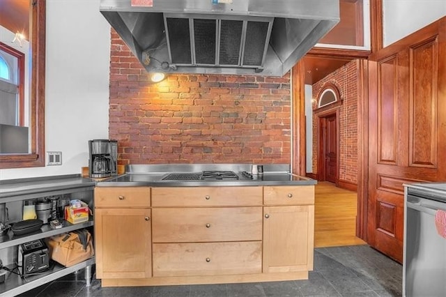 1 Pius St Unit B1, South Side, PA 15203 - kitchen featuring brick wall, range hood, gas cooktop, stainless steel countertops, and dishwasher