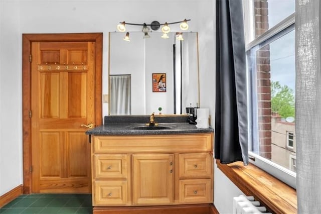 1 Pius St Unit B1, South Side, PA 15203 - bathroom with radiator, baseboards, vanity, and tile patterned floors