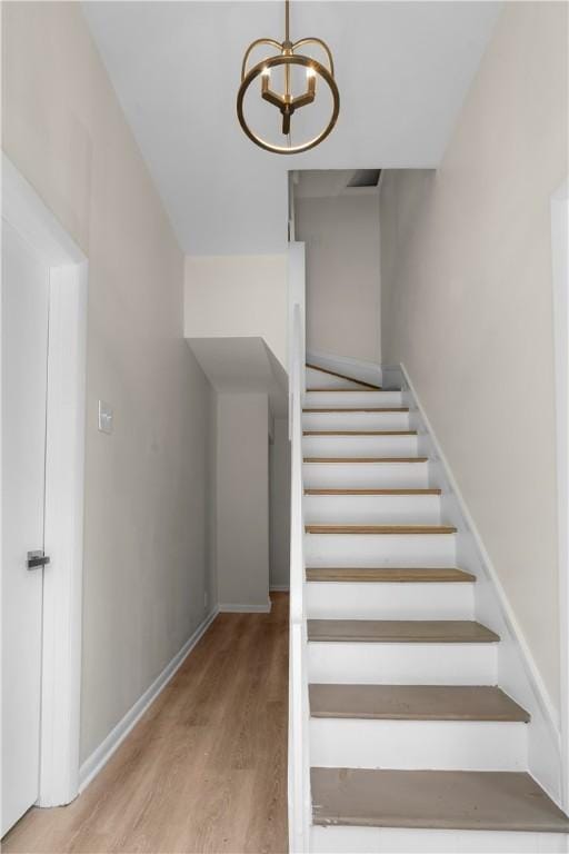 205 Berkley Ave, Forest Hills Boro, PA 15221 - stairs with baseboards, an inviting chandelier, and wood finished floors