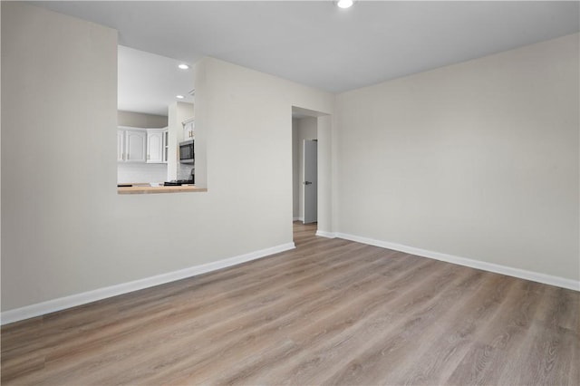 205 Berkley Ave, Forest Hills Boro, PA 15221 - unfurnished living room featuring recessed lighting, baseboards, and wood finished floors