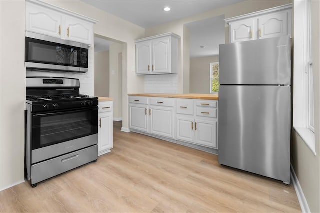 205 Berkley Ave, Forest Hills Boro, PA 15221 - kitchen featuring light wood-style flooring, appliances with stainless steel finishes, white cabinets, and butcher block counters