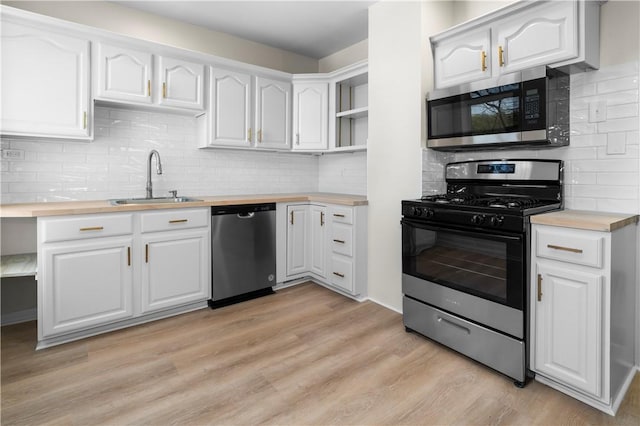 205 Berkley Ave, Forest Hills Boro, PA 15221 - kitchen featuring open shelves, decorative backsplash, butcher block countertops, a sink, and stainless steel appliances