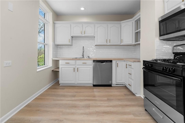 205 Berkley Ave, Forest Hills Boro, PA 15221 - kitchen featuring a sink, white cabinetry, a healthy amount of sunlight, and stainless steel appliances