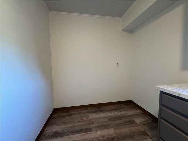 interior space featuring crown molding, baseboards, and dark wood finished floors