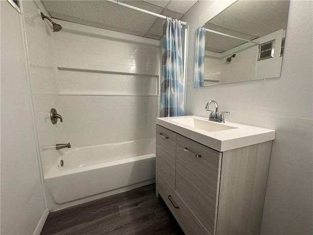 bathroom featuring shower / bath combo with shower curtain, a paneled ceiling, wood finished floors, and vanity