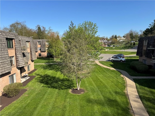 surrounding community with a yard