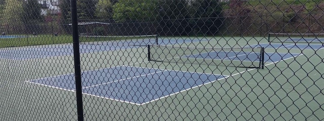 view of basketball court with fence